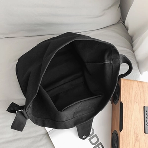 Minimalist black canvas tote bag with spacious interior and internal zipper pocket