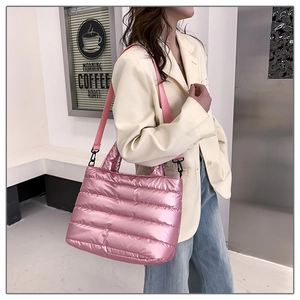 Close-up of pink quilted space cotton handbag with glossy finish and wide strap