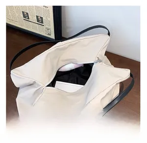 Top view of large canvas tote bag showing interior space with laptop and black lining