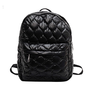 Chic black quilted down backpack with silver zipper for casual autumn and winter fashion