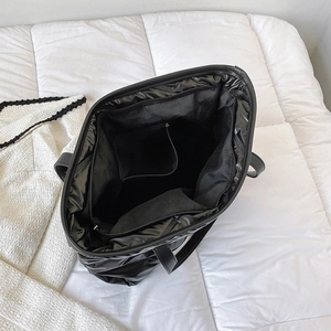 Quilted down puffer tote bag in black featuring spacious interior and zipper closure