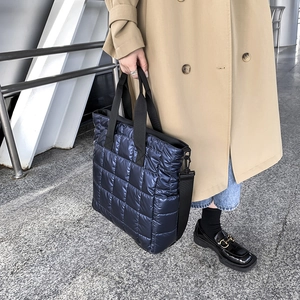 Quilted blue tote bag with metal gloss finish and wide shoulder strap for women