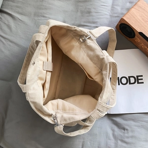 Beige corduroy large capacity tote bag with organized internal pockets and lining
