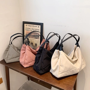 Minimalist large capacity shoulder bag in four colors with geometric folding design