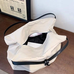 Large capacity off-white canvas tote bag with black leather straps and zipper closure