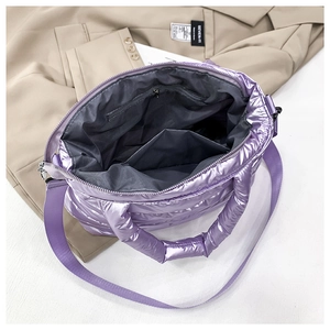 Detail view of the purple padded tote bag interior with zipper pocket and metal luster finish
