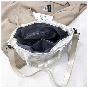 Detail view of the quilted space cotton bag showing interior compartments and zip pocket