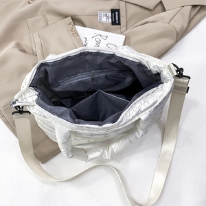 Detail view of the interior compartment featuring a zipper pocket and two open slots