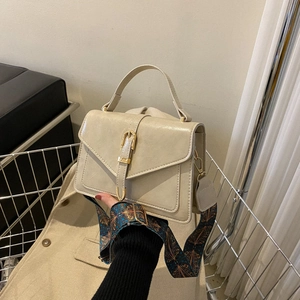 Retro cream leather handbag with bohemian print strap and gold buckle closure