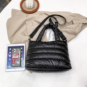 Chic black quilted puffer crossbody bag with glossy finish and adjustable strap