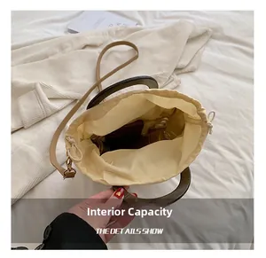 Top view of the spacious inner capacity and drawstring closure of this straw tote bag