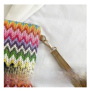 Detail of colorful woven handbag with rainbow texture and high-quality gold metal clasp