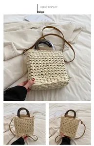 Detail of handmade woven beige handbag with vintage wooden handle and leather strap