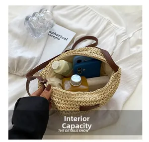 Top view showing the large internal capacity of the beige straw bucket bag with items