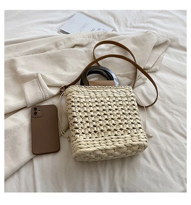 Detailed view of straw woven texture with wooden handle and drawstring closure