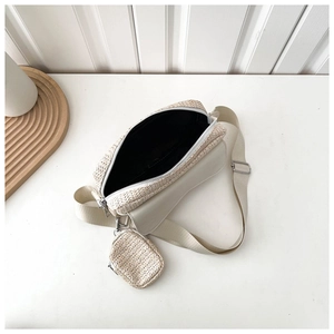 Detail of cream straw crossbody bag with leather flap and small hanging coin purse