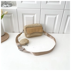 Detail of woven straw crossbody bag with mini round coin purse and nylon shoulder strap