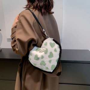 Faux fur heart-shaped shoulder bag with green heart print and Believe in yourself tag