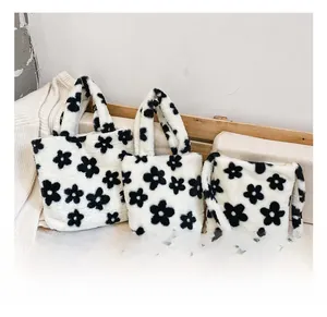Vue détaillée des sacs à main à fleurs en peluche avec fausse fourrure blanche et motifs