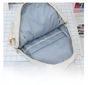 Interior view showing the large capacity and grey lining of the cream white backpack