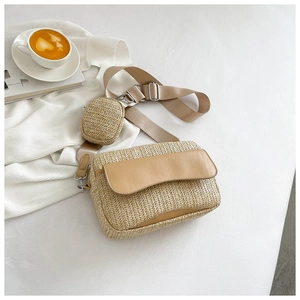 Detail of woven straw crossbody bag set with leather flap on warm white background