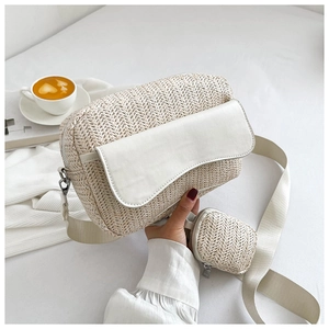 Detail of beige woven crossbody bag with white leather flap and matching coin purse