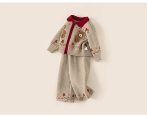 Detailed close-up of girls' knit cardigan featuring a cute bear pattern and red collar