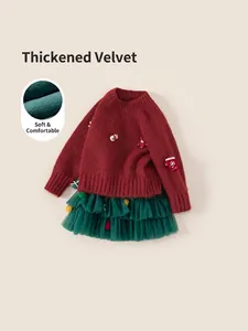 Girl's festive Christmas outfit with red knit sweater and green tulle tutu skirt