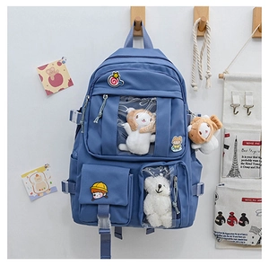Detail of grey-blue school backpack featuring clear PVC heart window for plush doll display