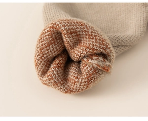 Detailed close-up of knitted cuffs showing beige and caramel jacquard texture