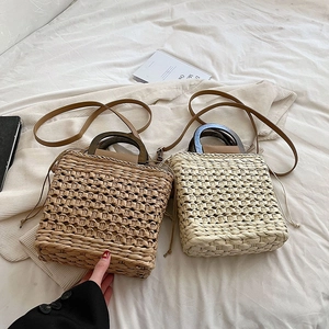 Fashionable woven straw handbag with wooden handles and crossbody strap in two colors