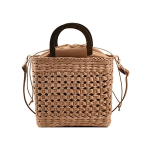 Handmade woven straw handbag with round wooden handles and adjustable leather shoulder strap