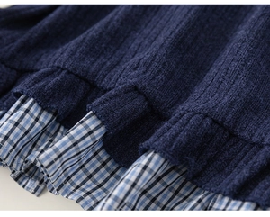 Detailed close-up of navy knit top with gingham ruffle hem for girls spring outfit