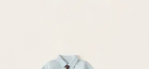 Close-up of light blue kids' dress shirt with a solid brown necktie for a formal suit
