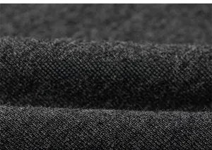 Macro close-up of high-quality black knitted cotton fabric with fine texture and soft feel