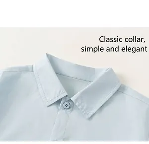 Close-up of light blue cotton shirt featuring classic collar and neat button details