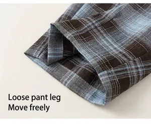 Detailed macro view of checkered trousers cuff with brown and light blue weave texture