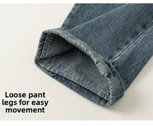 Detail view of loose-fit denim leg hem with premium stitching on blue twill fabric