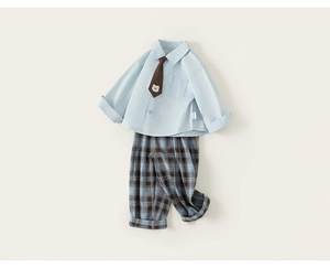 Detail of light blue boys shirt with brown bear tie and plaid pants school outfit