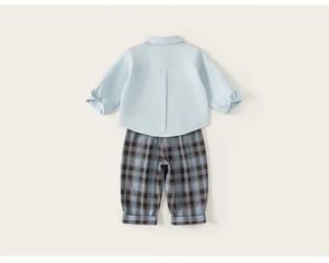 Rear view of children's blue cotton shirt with central pleat and plaid trousers with cuffed hems