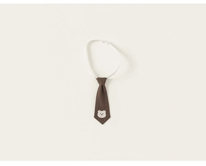 Detail of dark brown pet necktie with cute white bear embroidery and adjustable strap