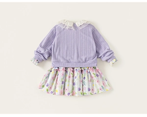 Detail view of girls' purple knit top with delicate lace embroidery and floral skirt