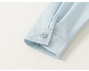 Detail of light blue cotton shirt cuff with high-quality single button closure and stitching