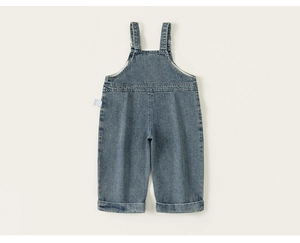 Detailed view of kids denim overalls featuring adjustable straps and rolled-up cuffs