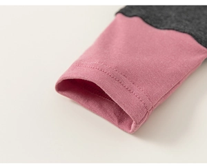 Close-up of pink and grey ribbed cuffs with high-quality double-needle stitching detail