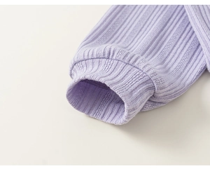 Detailed close-up of lavender knit fabric with vertical ribbing and hollow-out patterns