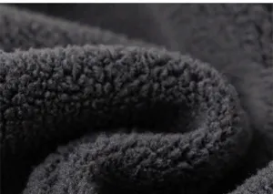 Close-up of thick dark grey fleece fabric showing soft texture and warm fiber detail