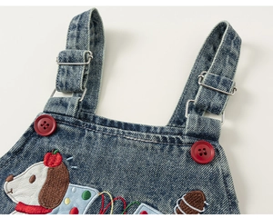 Detail of kids denim overalls featuring red buttons and a cute puppy embroidery