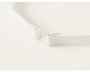 Macro detail of elastic suspender strap with clear adjustable buckle on kids suit