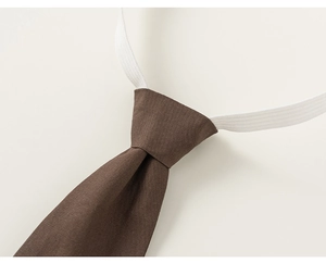 Detailed macro view of dark brown pre-tied necktie with elastic strap and woven texture